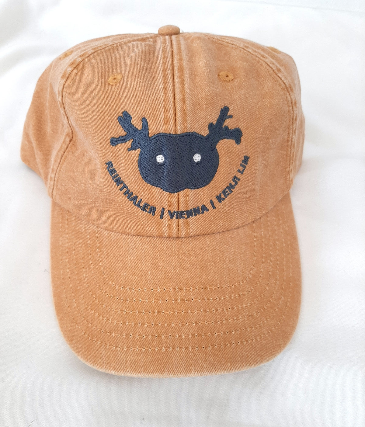 Frontal view of the mustard Artist Vintage Cap by Kenji Lim.