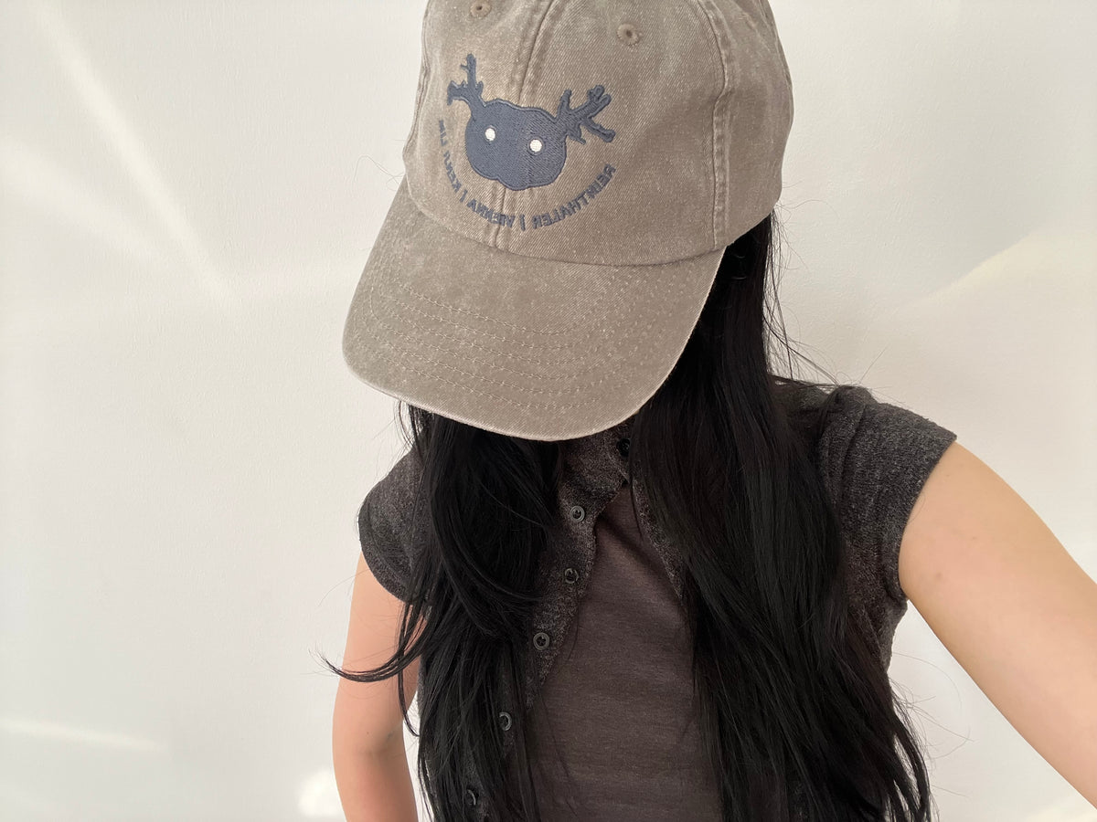 Gallery Assistant wearing the cap.