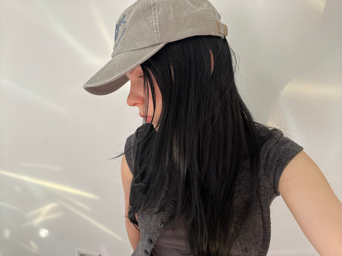 Gallery Assistant wearing the cap.